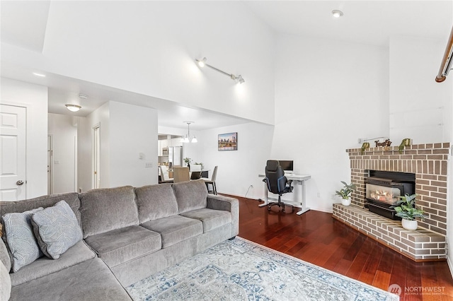 living area featuring a high ceiling and wood finished floors