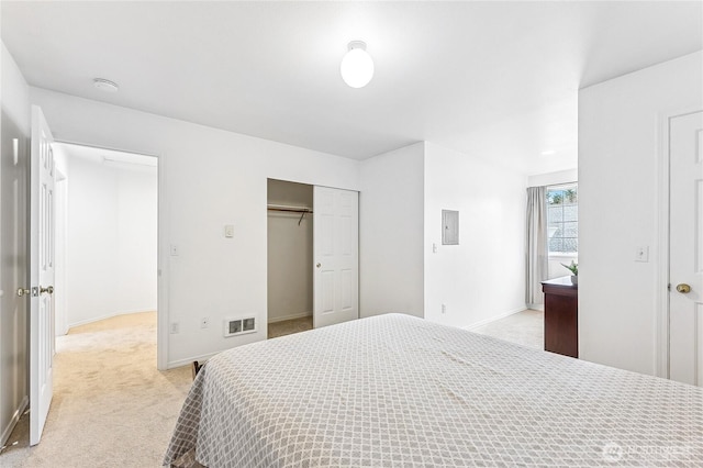 bedroom featuring visible vents, light carpet, electric panel, a closet, and baseboards