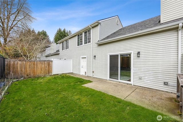 rear view of house featuring a patio area, a lawn, and fence