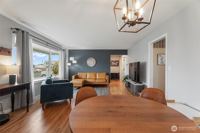 dining room featuring visible vents, an inviting chandelier, and light wood finished floors