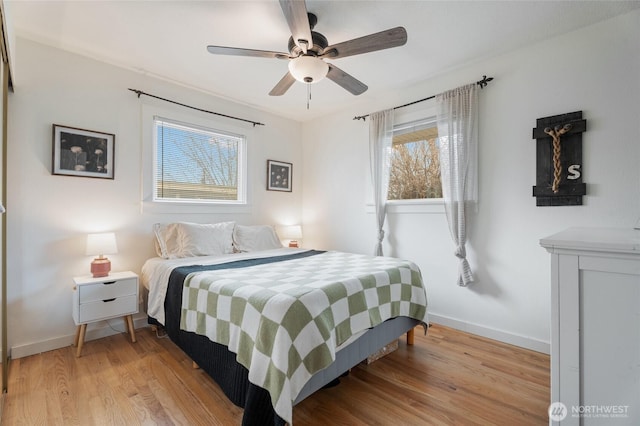 bedroom featuring light wood finished floors, ceiling fan, and baseboards