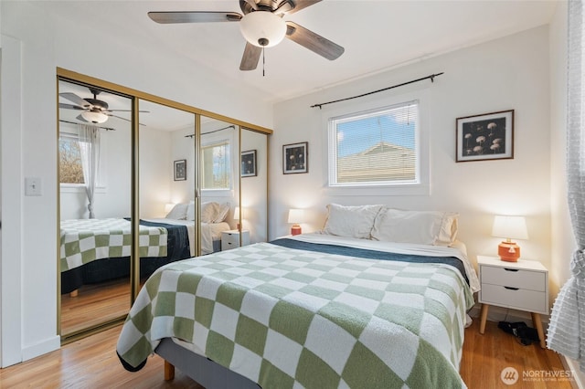 bedroom with wood finished floors, a closet, and ceiling fan