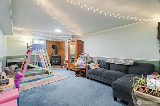 game room featuring a wood stove and carpet floors