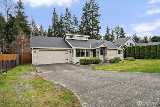 view of front of home featuring a front yard, fence, an attached garage, a shingled roof, and concrete driveway