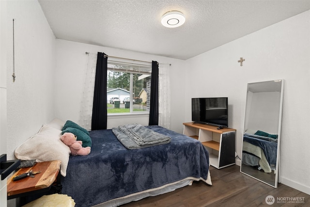 bedroom featuring a textured ceiling and wood finished floors