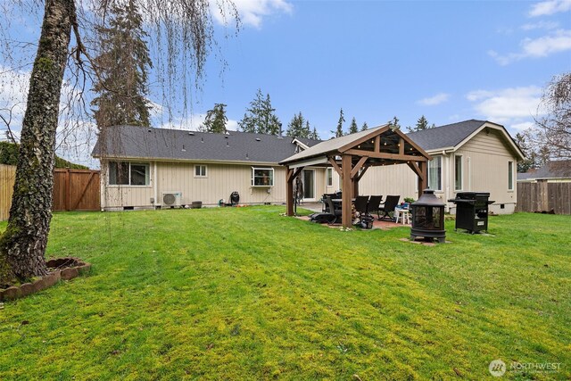 rear view of property with a patio, a yard, a fenced backyard, a gazebo, and crawl space