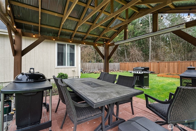 view of patio featuring area for grilling, outdoor dining area, and fence