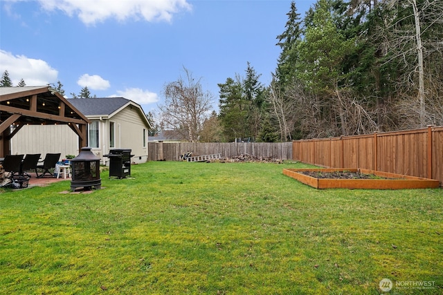 view of yard featuring a gazebo, a garden, a fenced backyard, and an outdoor fire pit