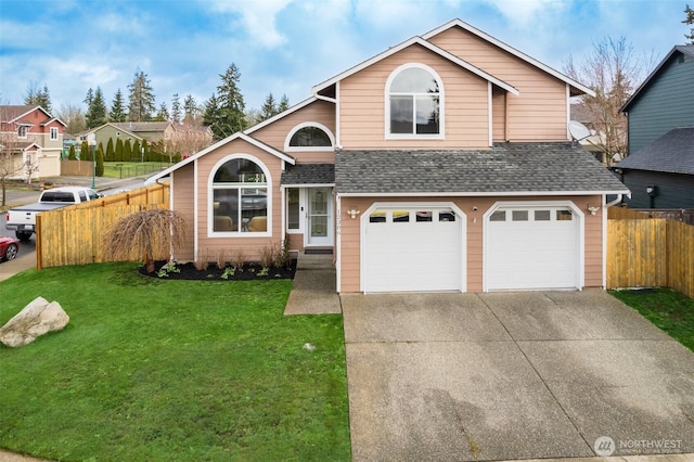 view of front of house featuring driveway, a front lawn, fence, an attached garage, and a shingled roof