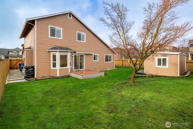 back of property with an outbuilding, a lawn, a storage shed, and a fenced backyard