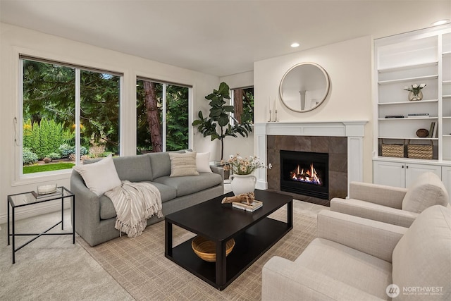 living area featuring plenty of natural light, recessed lighting, and a tile fireplace