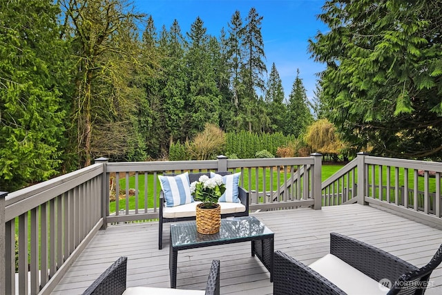 deck featuring a lawn and outdoor lounge area