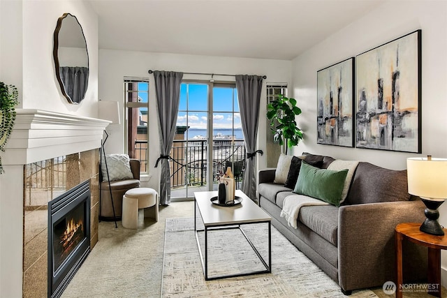 living area featuring a tiled fireplace and carpet