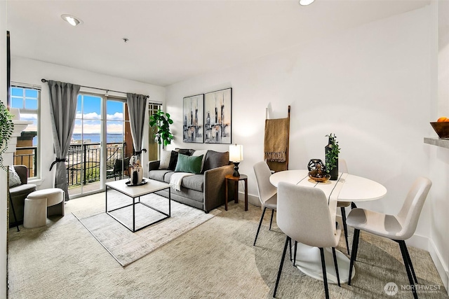 living area with recessed lighting, baseboards, and carpet floors