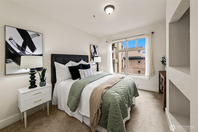 bedroom with baseboards and carpet floors