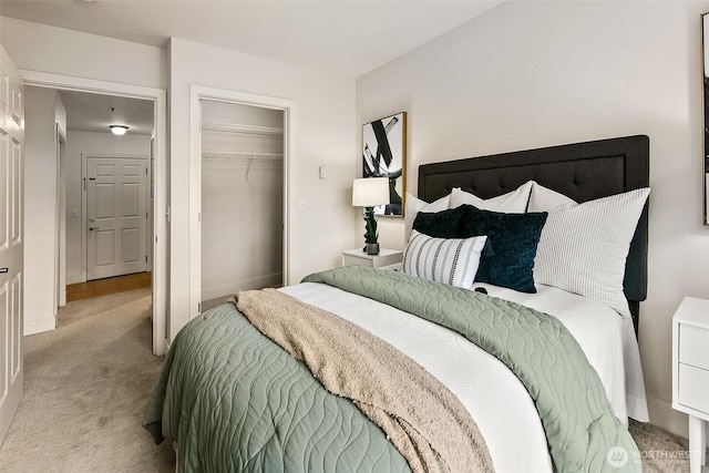 carpeted bedroom featuring a closet and baseboards