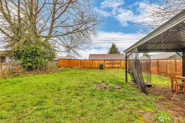 view of yard featuring a gazebo and a fenced backyard