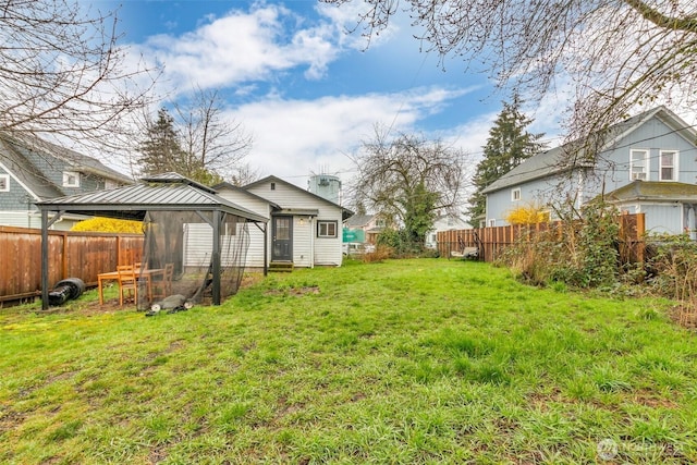 view of yard featuring a gazebo and a fenced backyard