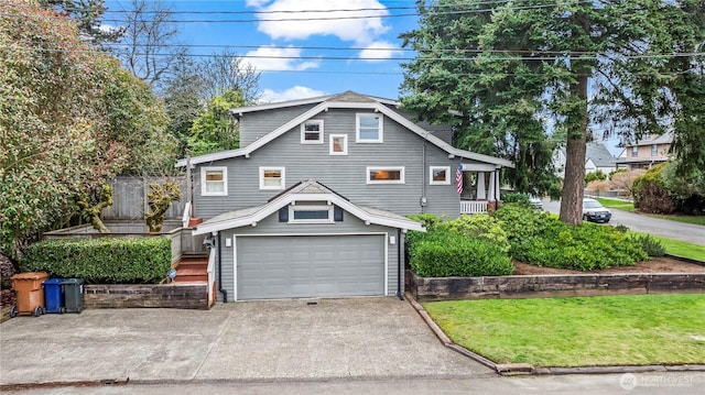 view of front of home featuring a front lawn, an attached garage, and driveway