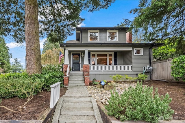 view of front of house featuring a porch and fence