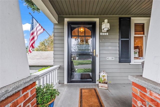 view of exterior entry featuring a porch