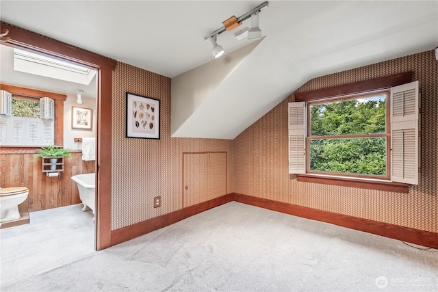 bonus room featuring light carpet, vaulted ceiling, and wallpapered walls