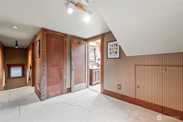 bonus room featuring carpet floors and wallpapered walls