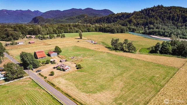 bird's eye view with a rural view, a wooded view, and a water view