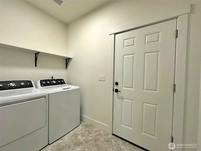 laundry room featuring baseboards, light colored carpet, laundry area, and washer and clothes dryer