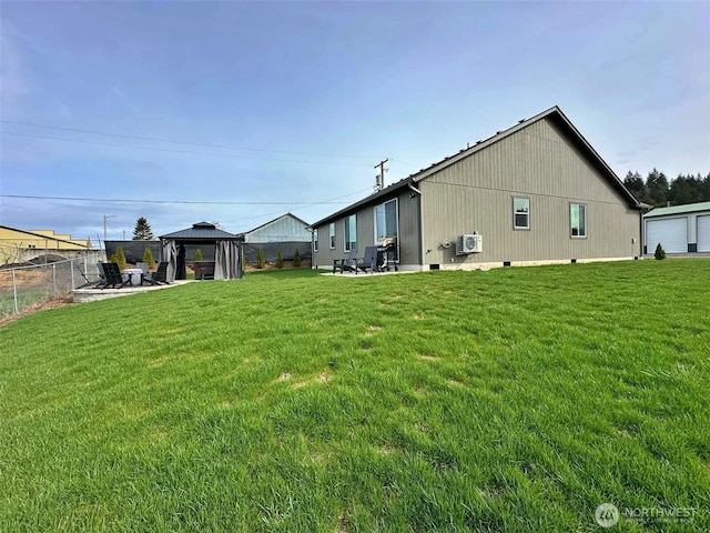 back of house with a gazebo, a patio, a yard, and fence