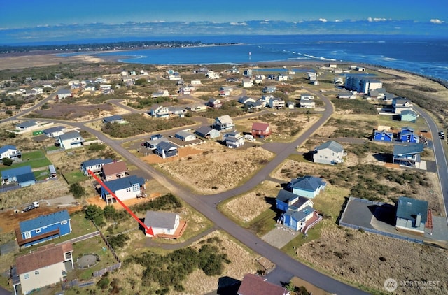 drone / aerial view featuring a residential view and a water view