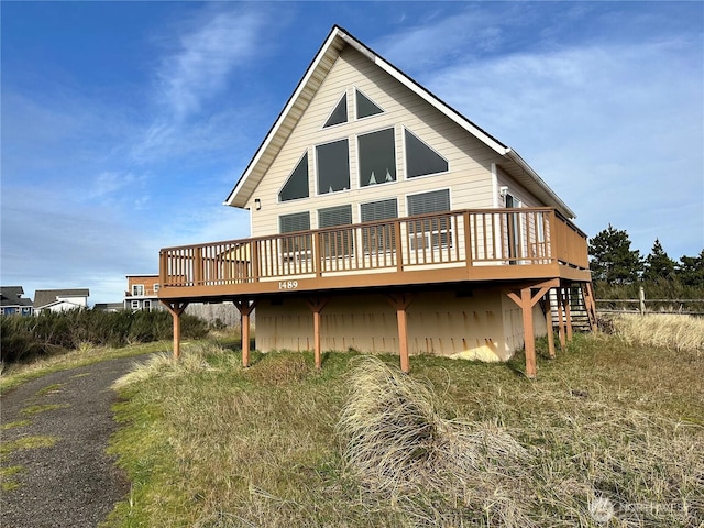 back of house with a wooden deck