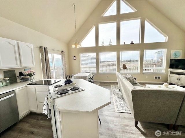 kitchen featuring a peninsula, dishwasher, white cabinets, and white electric range oven