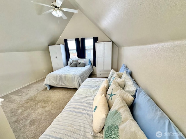 carpeted bedroom featuring lofted ceiling, a ceiling fan, baseboards, and a textured ceiling