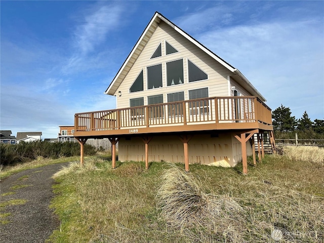 rear view of house with a wooden deck