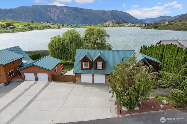 aerial view featuring a water and mountain view