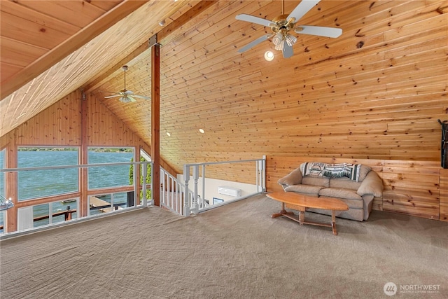 unfurnished room featuring beam ceiling, carpet, wood walls, and wooden ceiling