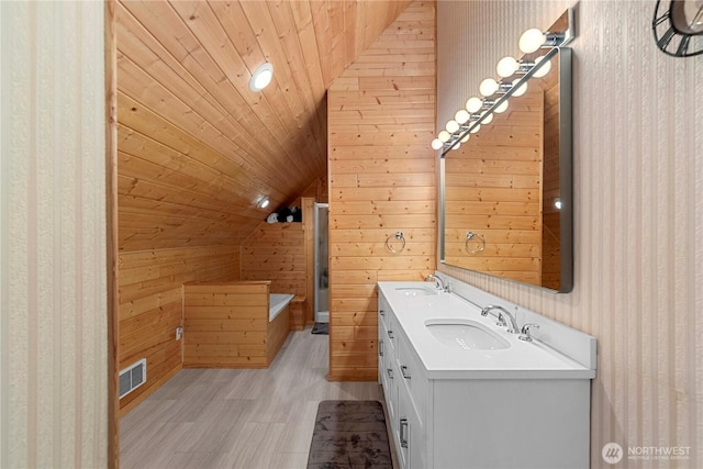 full bath featuring visible vents, lofted ceiling, a sink, wood ceiling, and a washtub