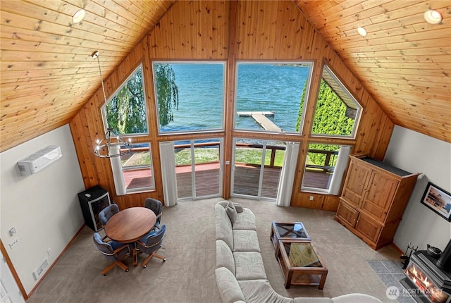 living area featuring wood ceiling, visible vents, light colored carpet, and a healthy amount of sunlight