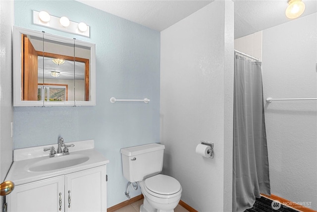 bathroom featuring a shower with shower curtain, baseboards, toilet, and vanity