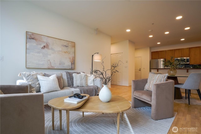 living room with recessed lighting and light wood-type flooring