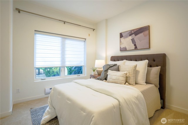 bedroom with baseboards and light carpet