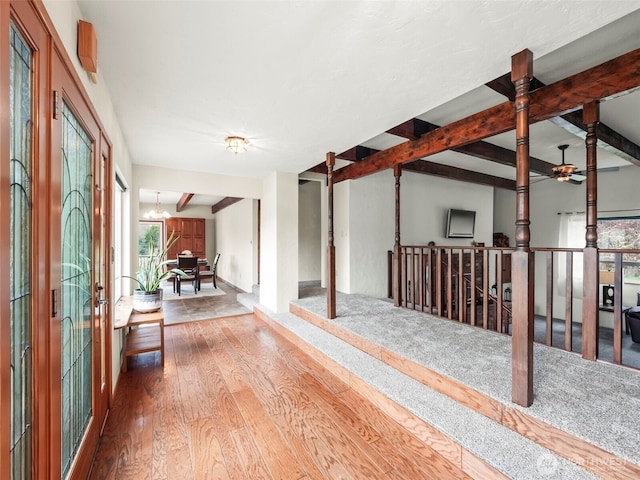 entryway featuring a chandelier, beamed ceiling, and hardwood / wood-style floors