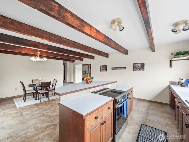 kitchen featuring baseboards, light countertops, beam ceiling, stainless steel electric range, and a notable chandelier