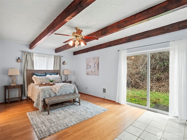 bedroom featuring beam ceiling, visible vents, access to exterior, and wood finished floors