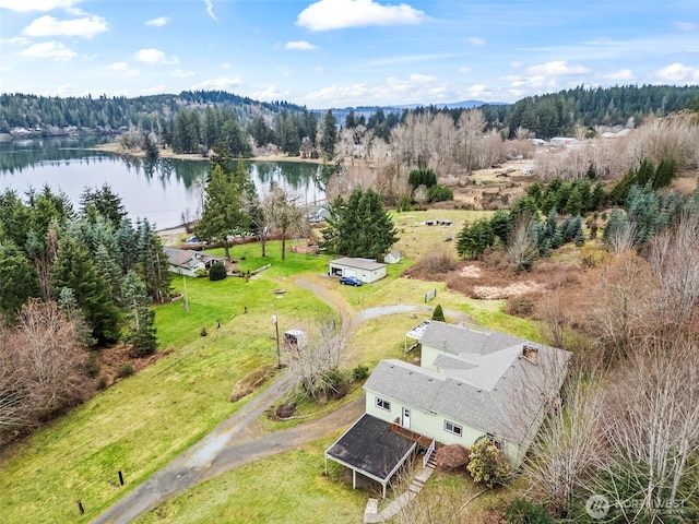 drone / aerial view with a view of trees and a water view