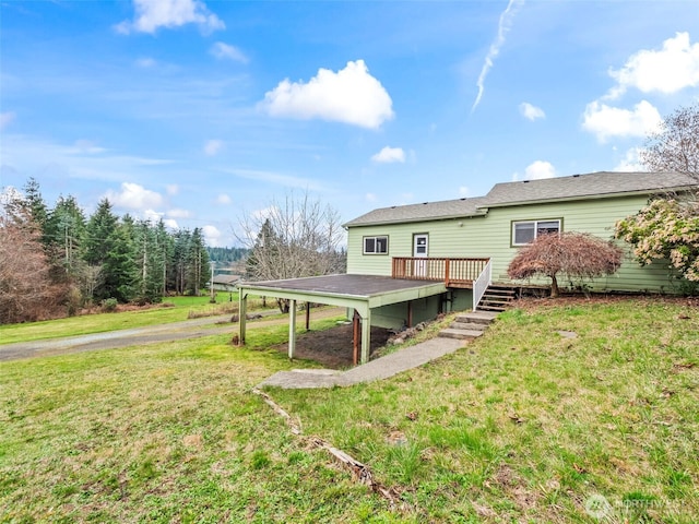 back of house with a lawn and a deck