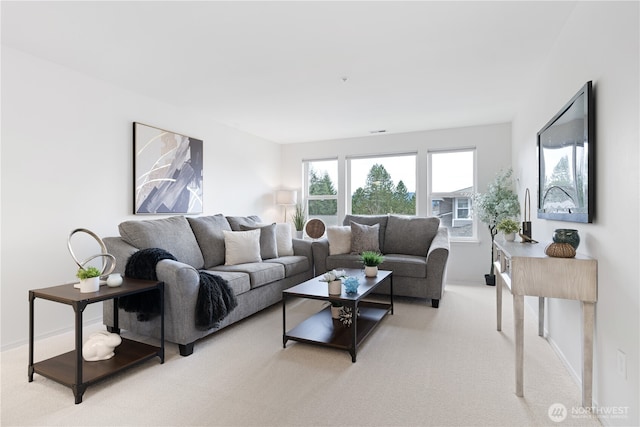 carpeted living room featuring baseboards