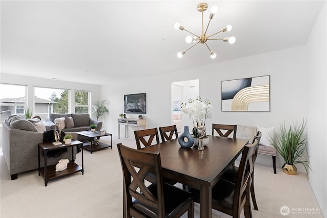 dining room with light colored carpet and an inviting chandelier