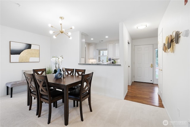 dining area featuring recessed lighting, baseboards, light colored carpet, and an inviting chandelier